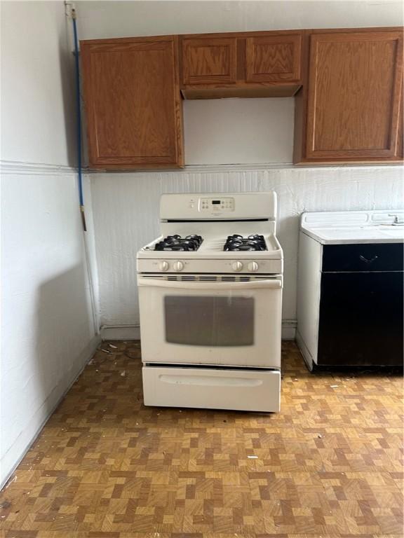 kitchen featuring light parquet floors and white gas range