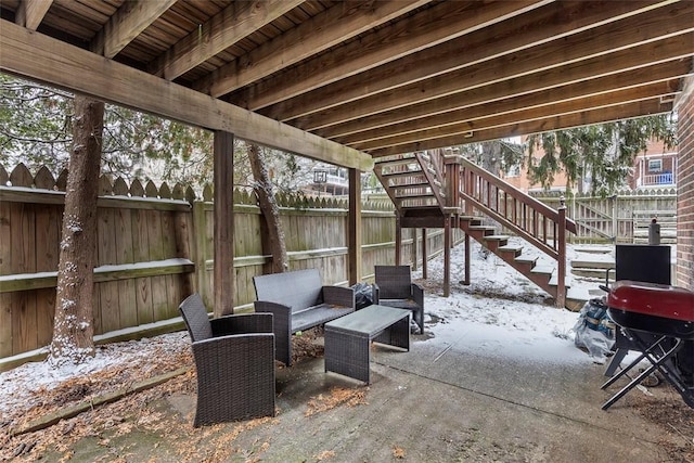 snow covered patio featuring an outdoor hangout area and a grill