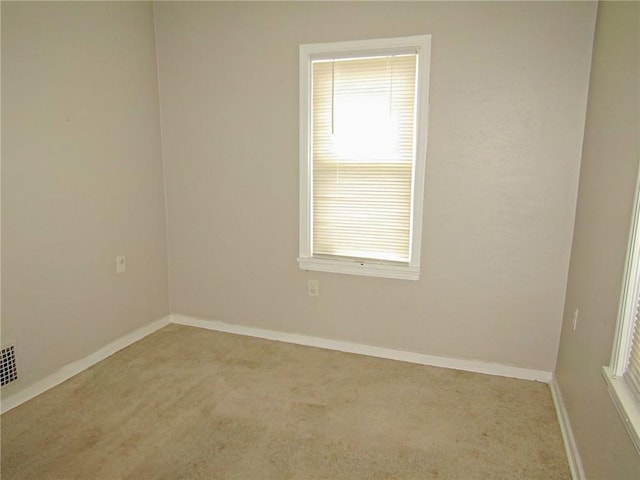 unfurnished room featuring light colored carpet