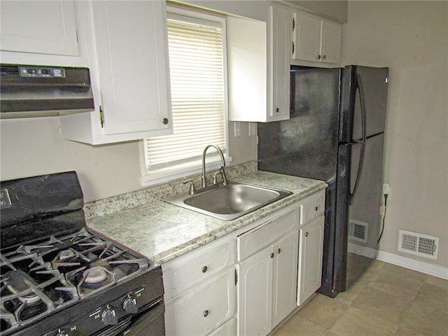 kitchen featuring range hood, black range with gas stovetop, white cabinets, and sink