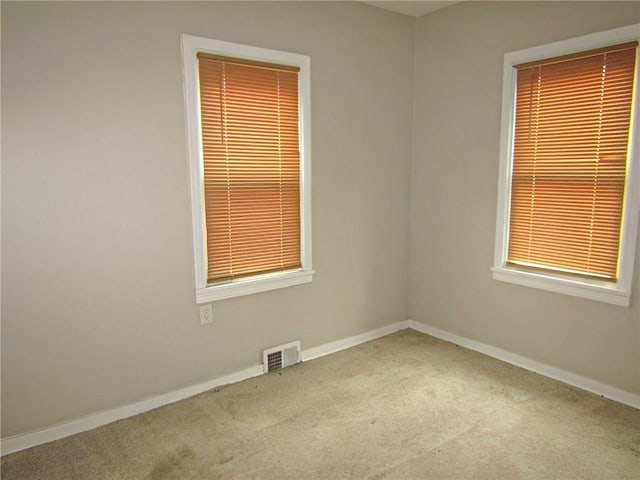 empty room featuring light carpet