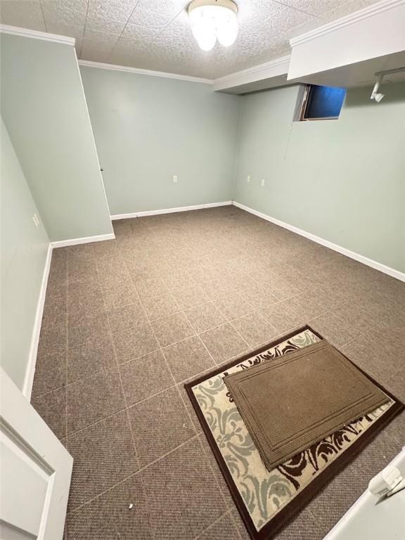 basement featuring crown molding and a textured ceiling