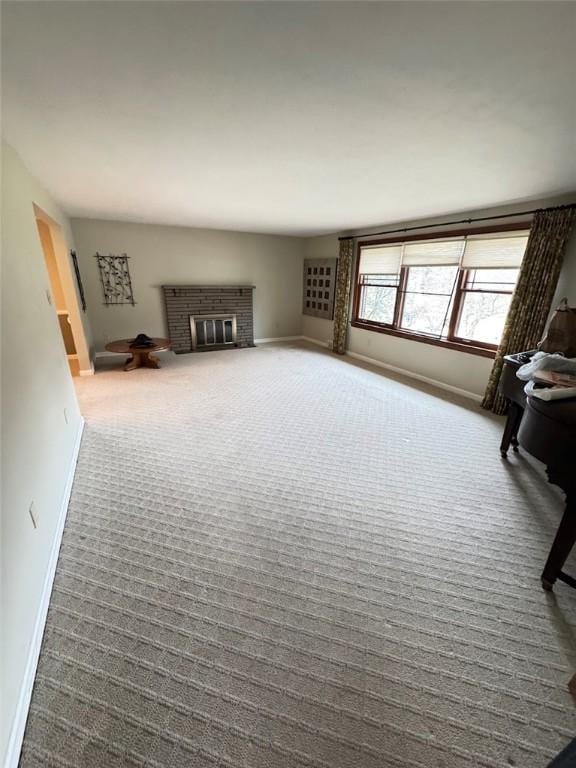 unfurnished living room featuring carpet and a fireplace