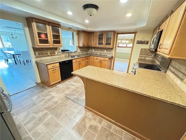 kitchen featuring range, dishwasher, decorative backsplash, sink, and kitchen peninsula