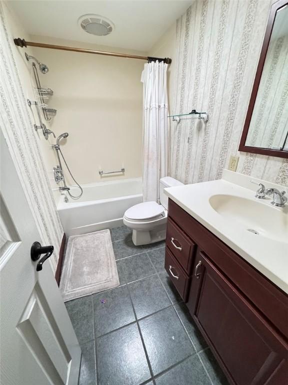 full bathroom with toilet, shower / tub combo, tile patterned floors, and vanity