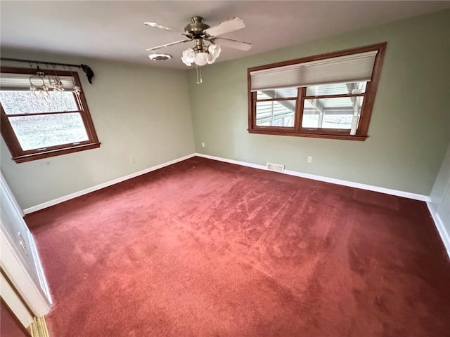 spare room with carpet, ceiling fan, and a wealth of natural light