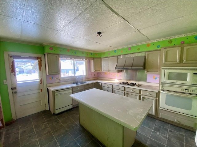 kitchen featuring a drop ceiling, range hood, a kitchen island, sink, and white appliances