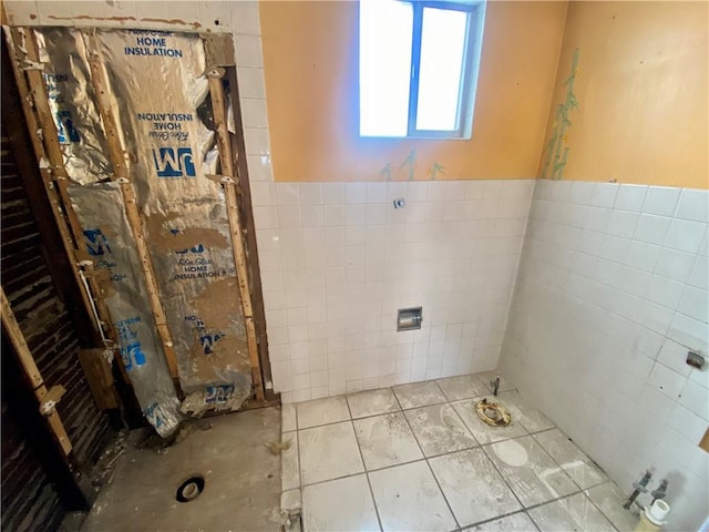 bathroom with tile walls