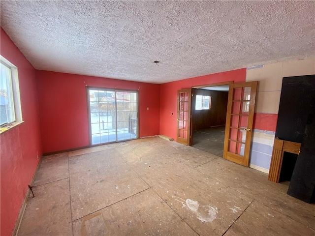 spare room featuring a textured ceiling and french doors