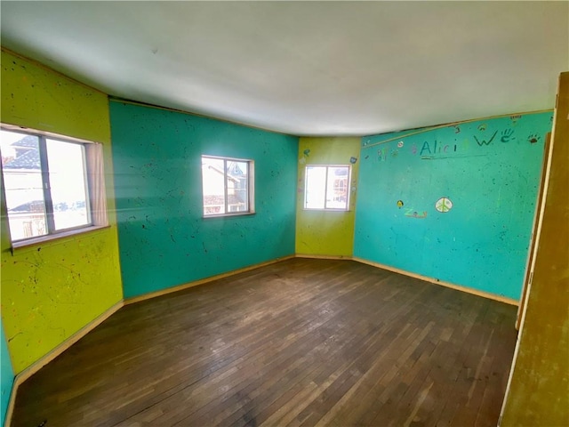 empty room with dark hardwood / wood-style floors