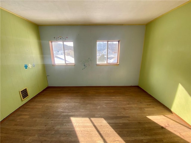 unfurnished room with hardwood / wood-style floors