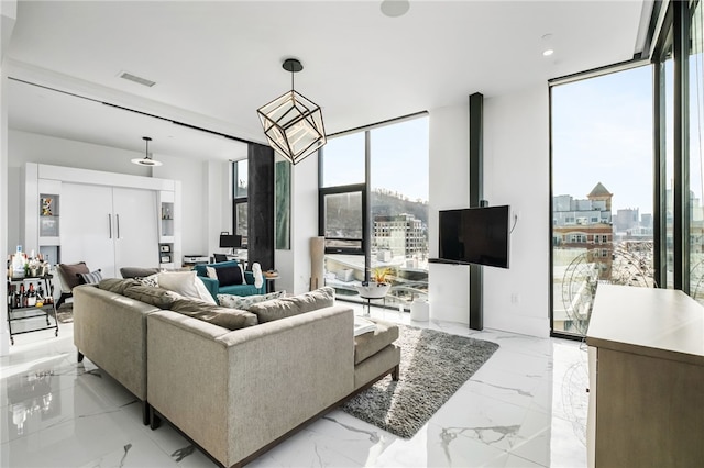 living room featuring expansive windows and a healthy amount of sunlight