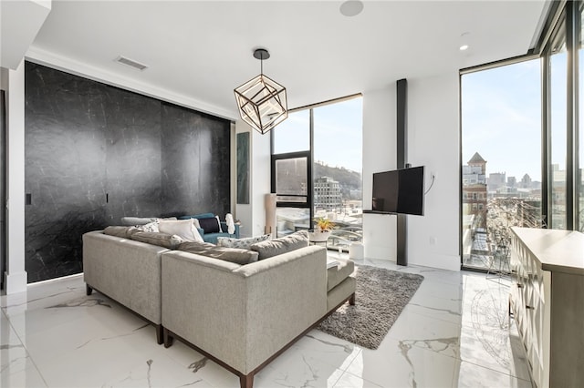 living room featuring a healthy amount of sunlight and floor to ceiling windows