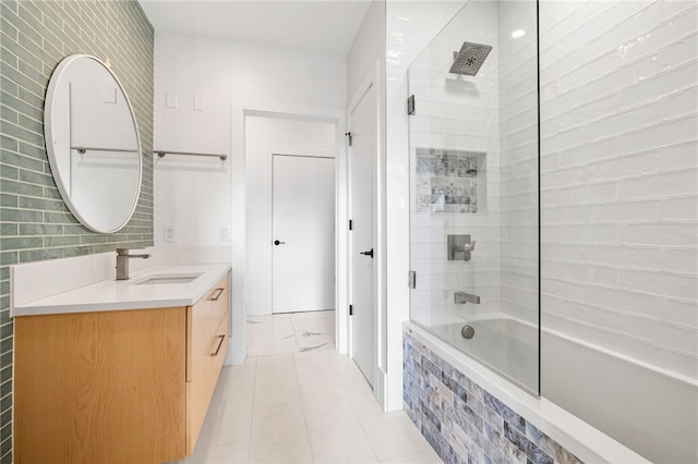 bathroom featuring combined bath / shower with glass door and vanity