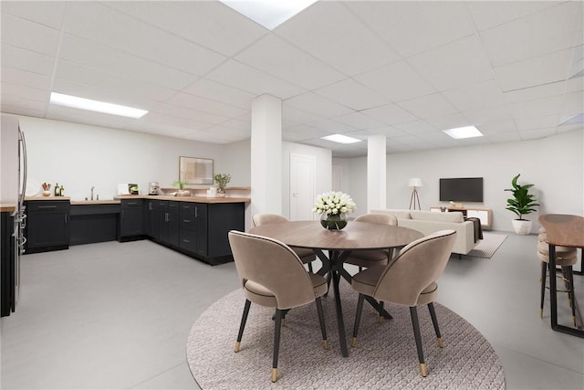 dining area featuring a paneled ceiling