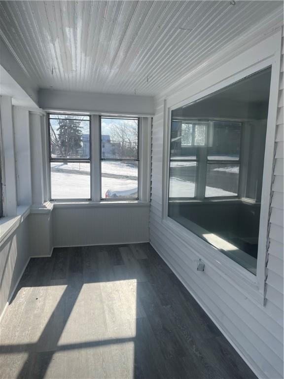 unfurnished sunroom with wood ceiling