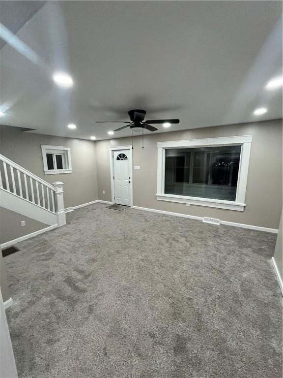 unfurnished living room with carpet flooring, recessed lighting, baseboards, a ceiling fan, and stairway