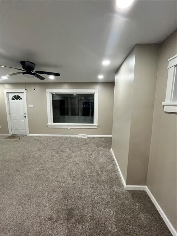 unfurnished living room with ceiling fan and carpet flooring