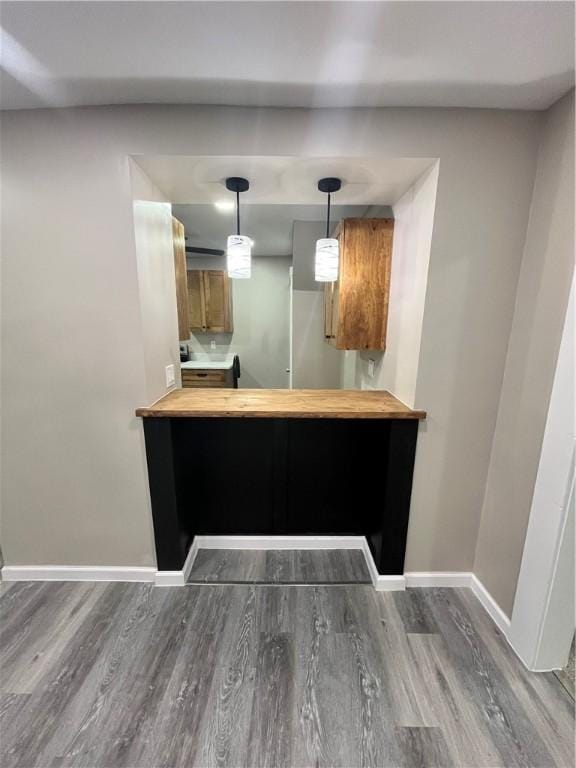 kitchen with hardwood / wood-style flooring, hanging light fixtures, and kitchen peninsula