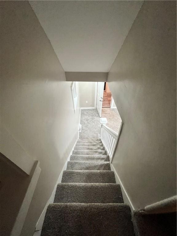 staircase with carpet flooring and baseboards