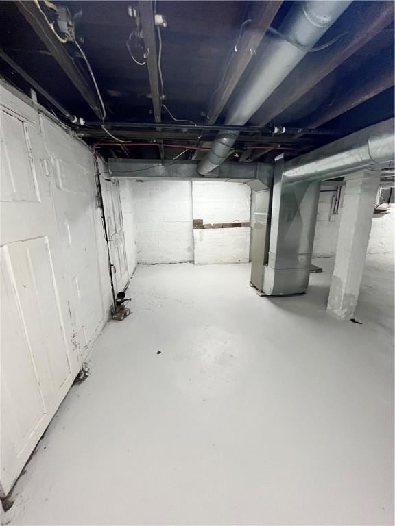 unfinished below grade area featuring heating unit
