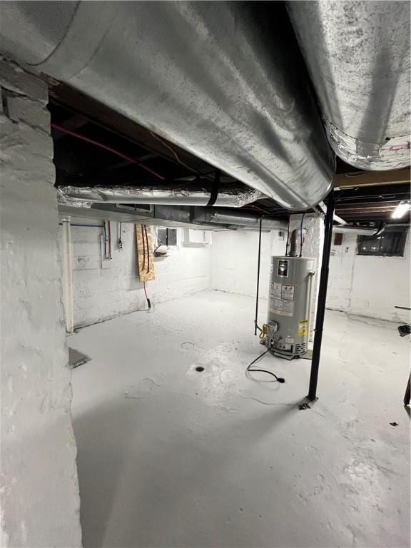 unfinished basement featuring gas water heater
