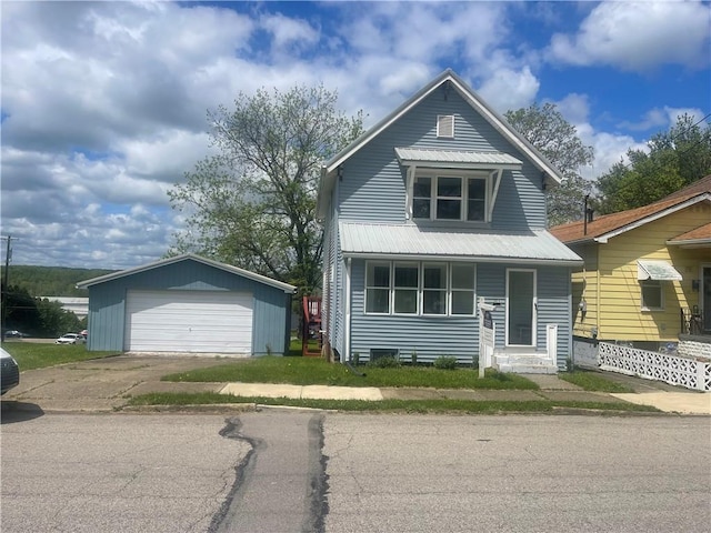 view of front of property featuring a detached garage, an outbuilding, and metal roof