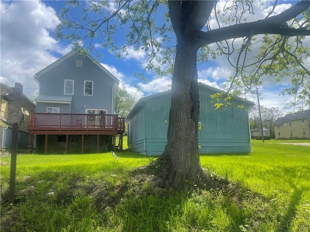 back of property with a yard and a deck