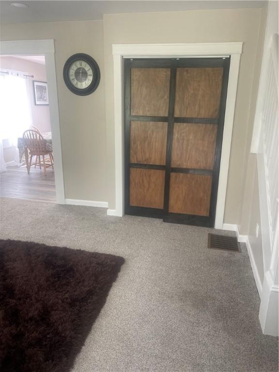 interior space featuring carpet floors and baseboards