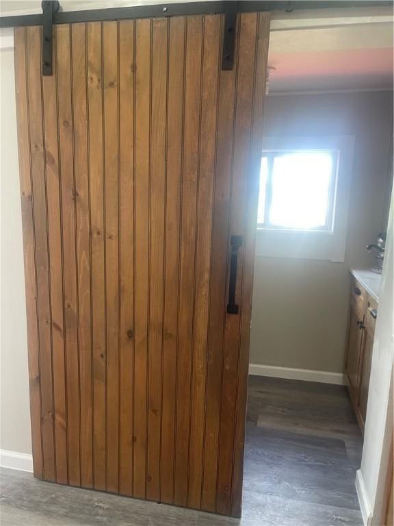 bathroom featuring wood finished floors, baseboards, and vanity