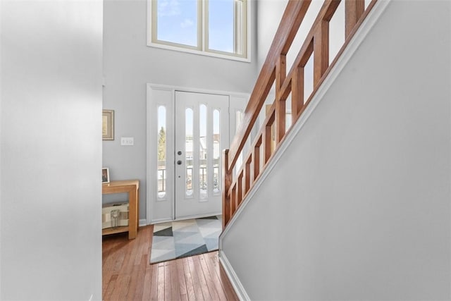 entrance foyer featuring light wood-type flooring and a high ceiling