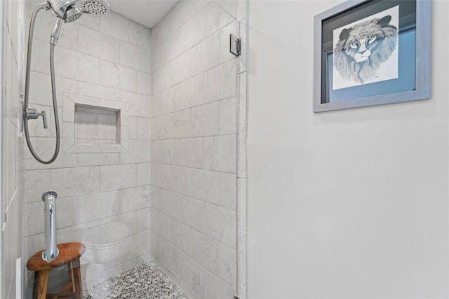 bathroom with a tile shower