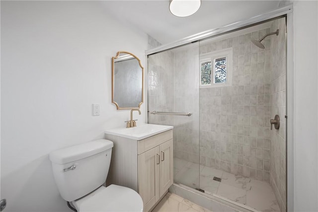 bathroom with an enclosed shower, vanity, and toilet