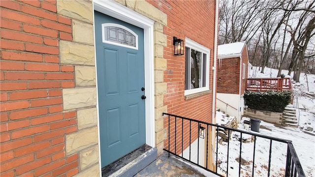 view of snow covered property entrance