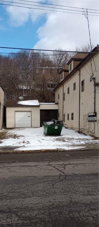 exterior space featuring a garage and an outdoor structure