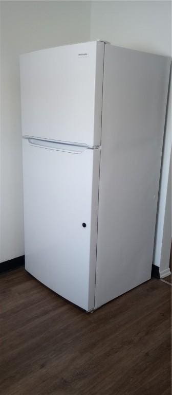 interior details featuring dark hardwood / wood-style flooring and white refrigerator