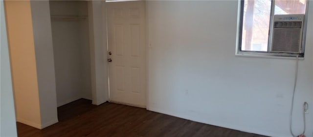 unfurnished bedroom featuring dark hardwood / wood-style floors and a closet