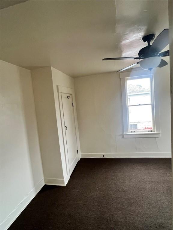 carpeted empty room with ceiling fan