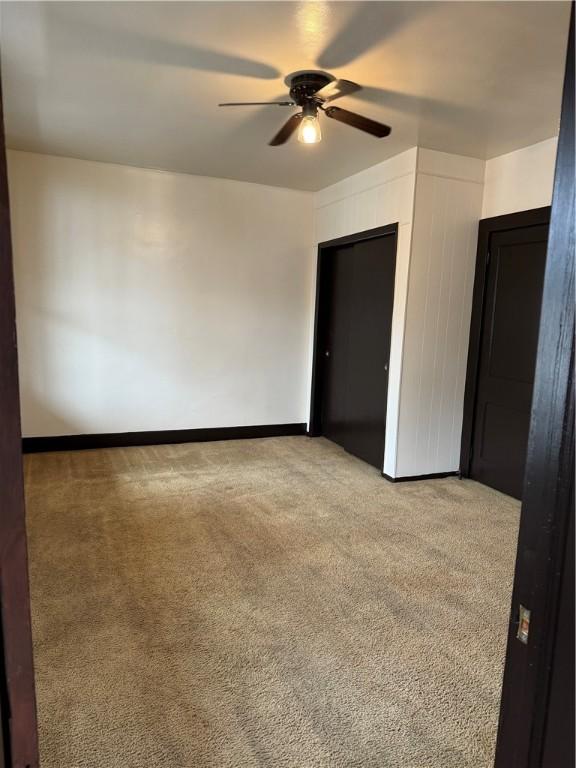 carpeted empty room with ceiling fan