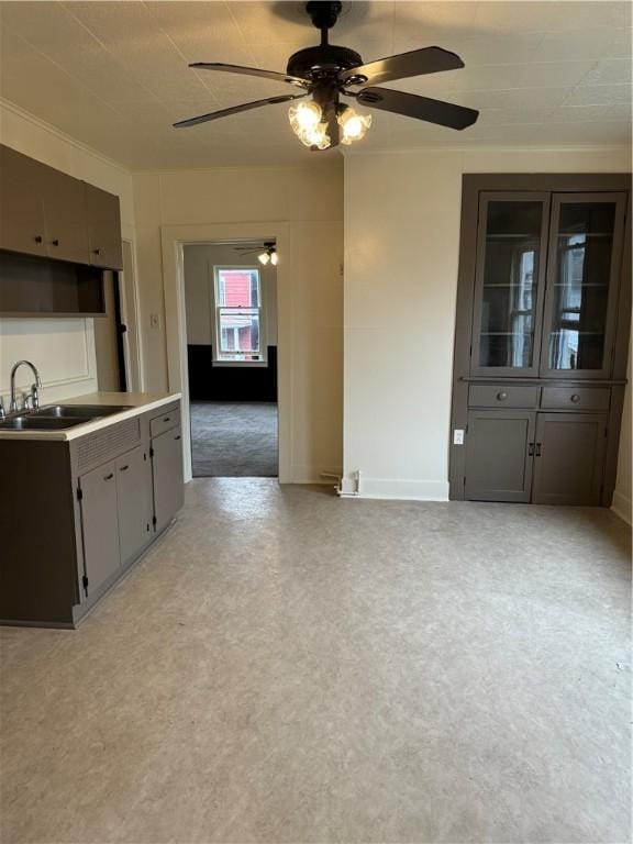 kitchen featuring ceiling fan and sink