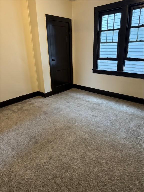 unfurnished room with light colored carpet