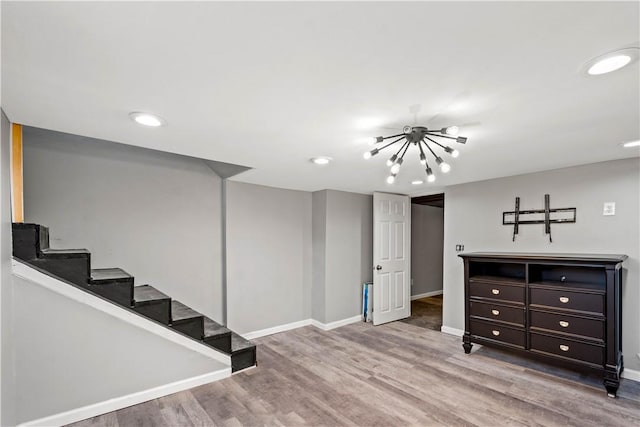 basement with recessed lighting, stairway, baseboards, and wood finished floors