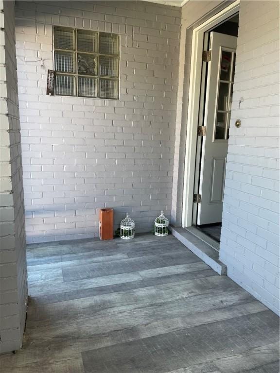 entrance to property featuring brick siding