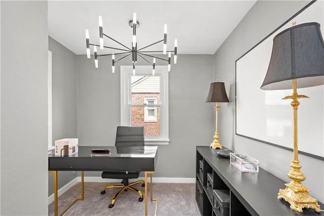 carpeted home office featuring a chandelier and baseboards