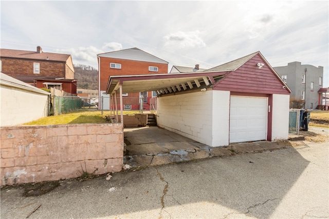 view of front of house with a garage and fence