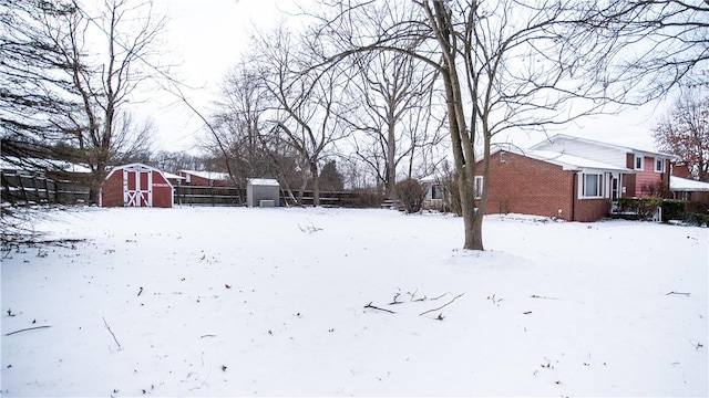 snowy yard with a shed