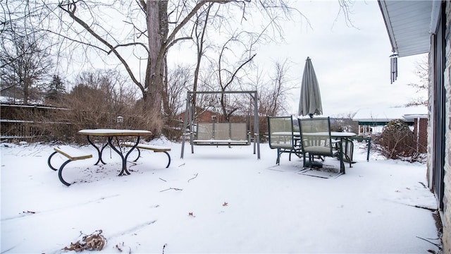 snowy yard with a trampoline