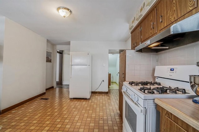 kitchen featuring white appliances and tasteful backsplash