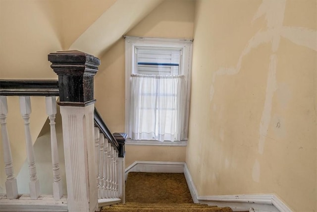 stairs featuring lofted ceiling