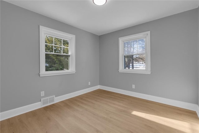 spare room featuring light hardwood / wood-style flooring